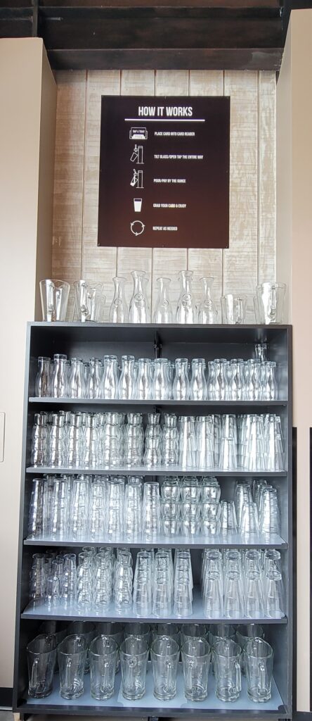 A shelf of unique wine and beer glasses